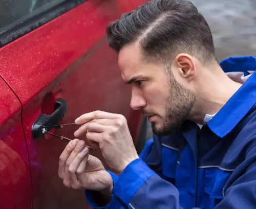 A car locksmith opening a car door
